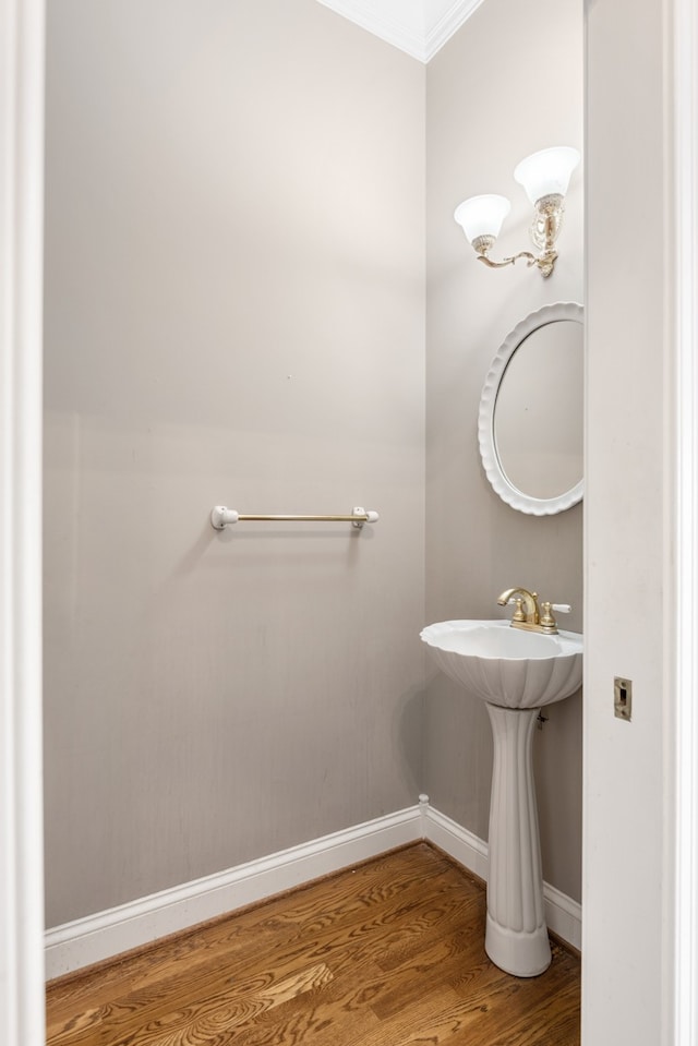 bathroom with hardwood / wood-style floors and crown molding