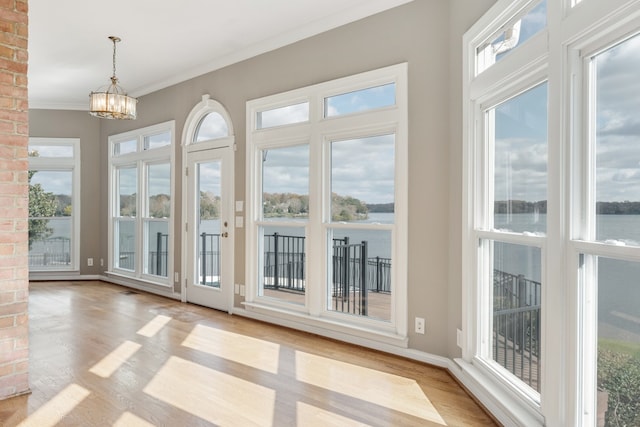 entryway featuring a wealth of natural light, a notable chandelier, and light wood-type flooring