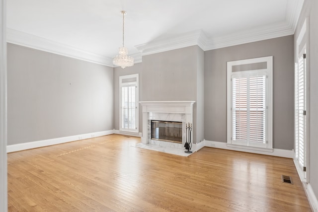 unfurnished living room featuring a fireplace, light hardwood / wood-style flooring, and crown molding