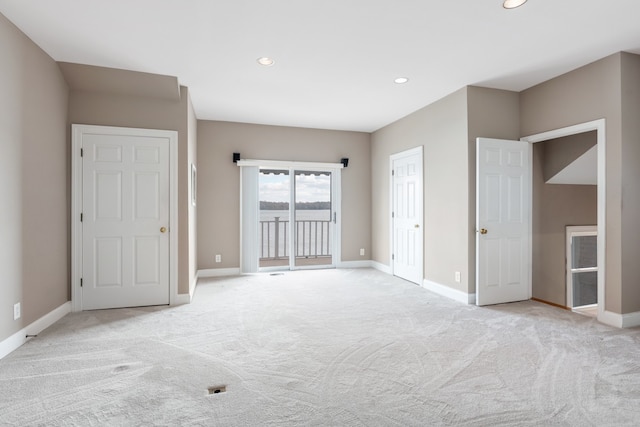 unfurnished bedroom with access to exterior and light colored carpet