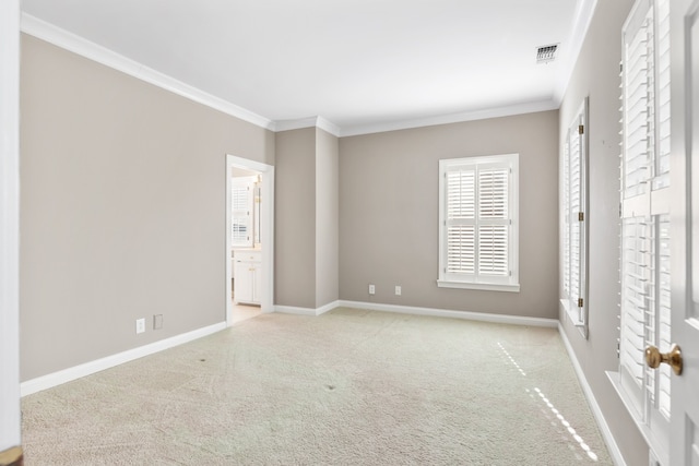 unfurnished bedroom with light colored carpet, ornamental molding, and connected bathroom