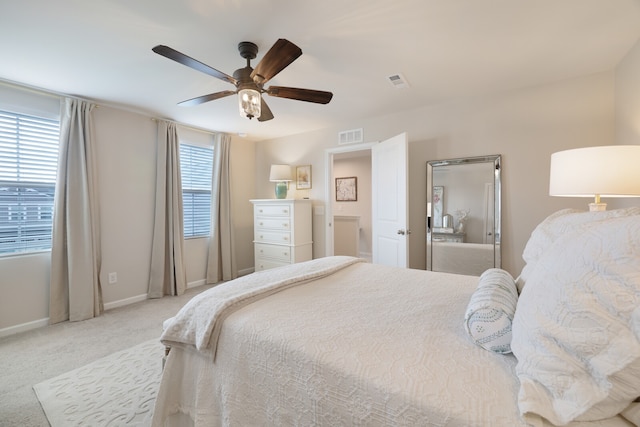 carpeted bedroom with multiple windows and ceiling fan