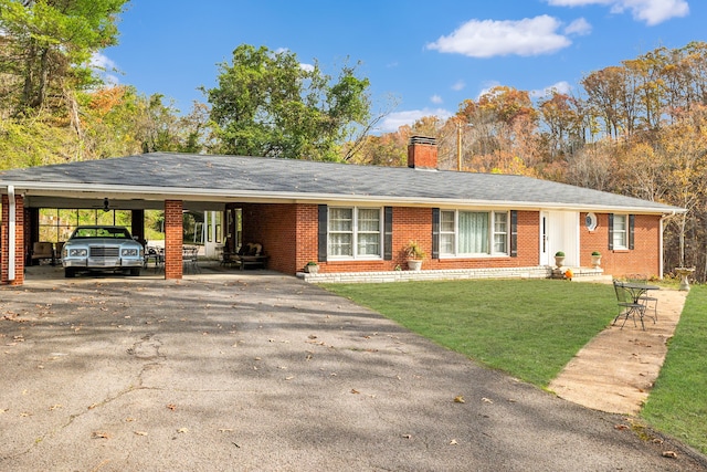 single story home with a front yard and a carport