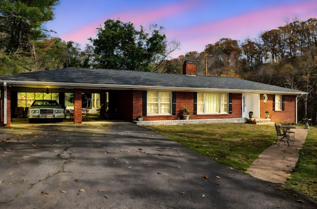 single story home with a carport and a lawn