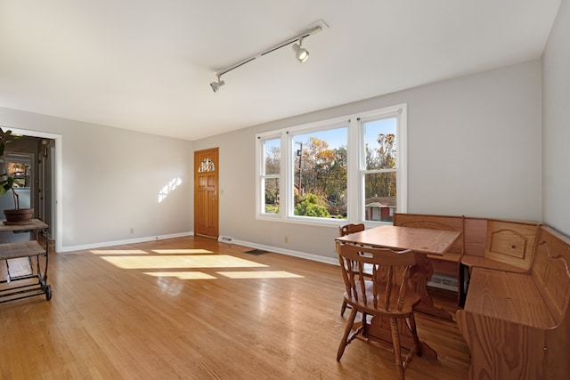 dining area featuring light hardwood / wood-style flooring and rail lighting