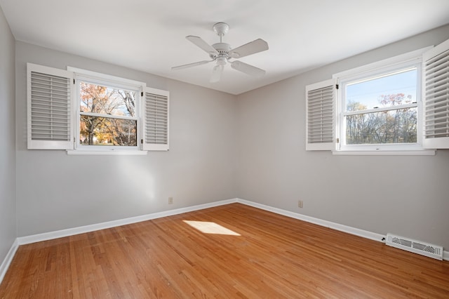 spare room with ceiling fan and hardwood / wood-style flooring