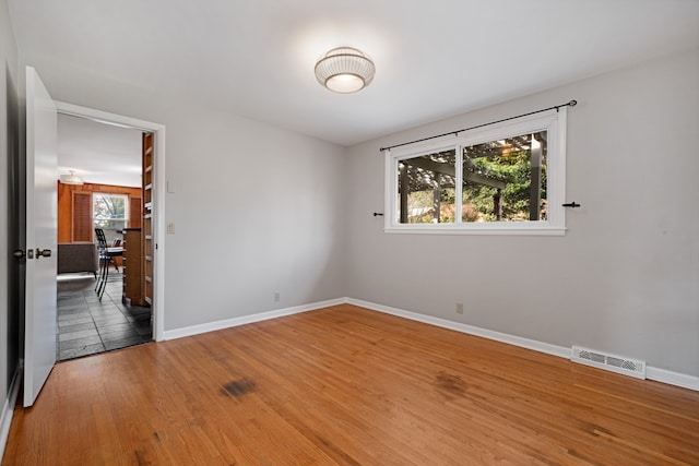 empty room with hardwood / wood-style flooring