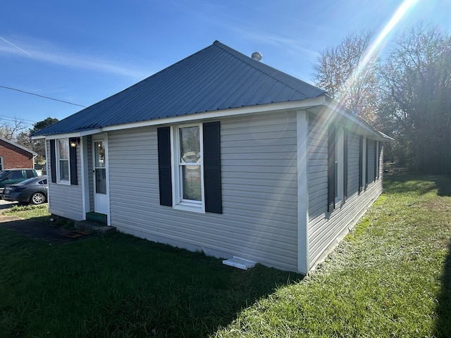 view of property exterior featuring a lawn