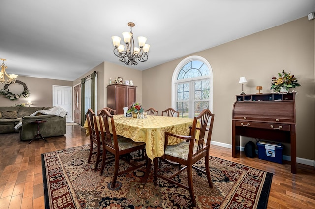 dining room featuring dark hardwood / wood-style flooring and a chandelier