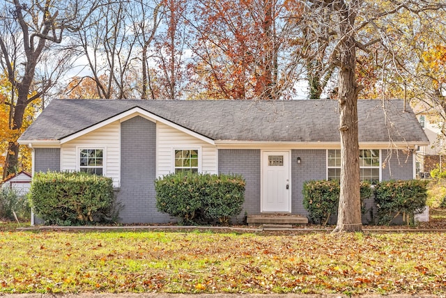 ranch-style home featuring a front yard