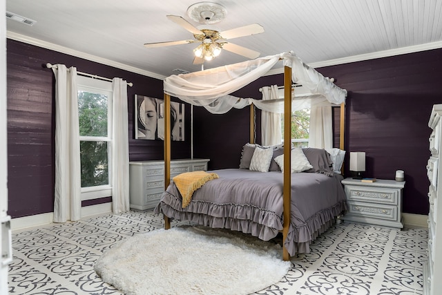 tiled bedroom featuring ceiling fan, wood walls, and ornamental molding