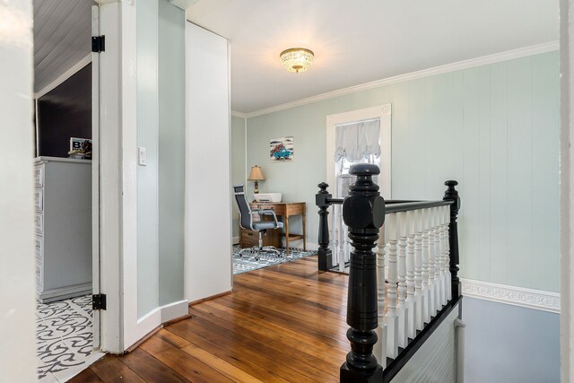 hall with wood-type flooring and crown molding