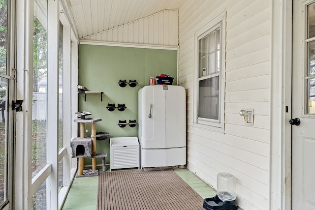 sunroom / solarium featuring vaulted ceiling and wooden ceiling