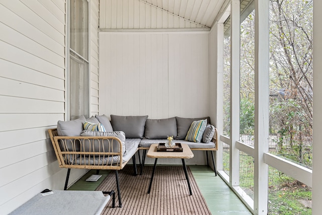 sunroom / solarium featuring a healthy amount of sunlight and vaulted ceiling