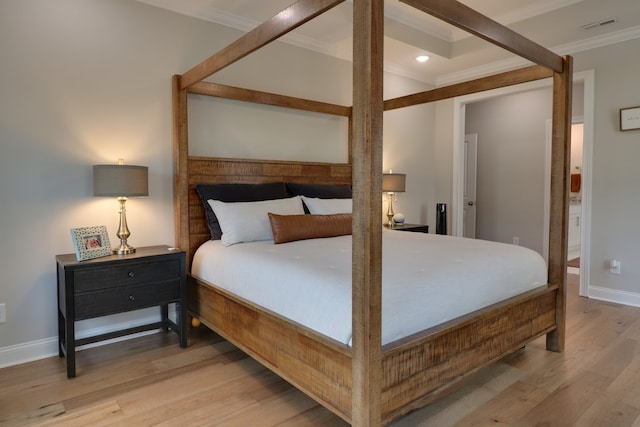 bedroom with crown molding and hardwood / wood-style floors