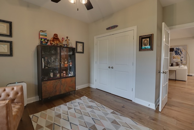 living area with hardwood / wood-style floors and ceiling fan