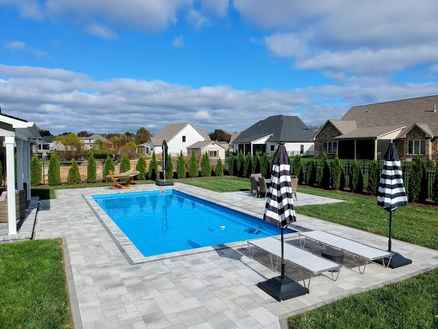 view of swimming pool featuring a patio area and a lawn