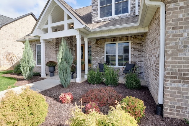 view of exterior entry featuring covered porch