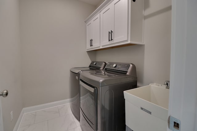 laundry room with separate washer and dryer, sink, and cabinets