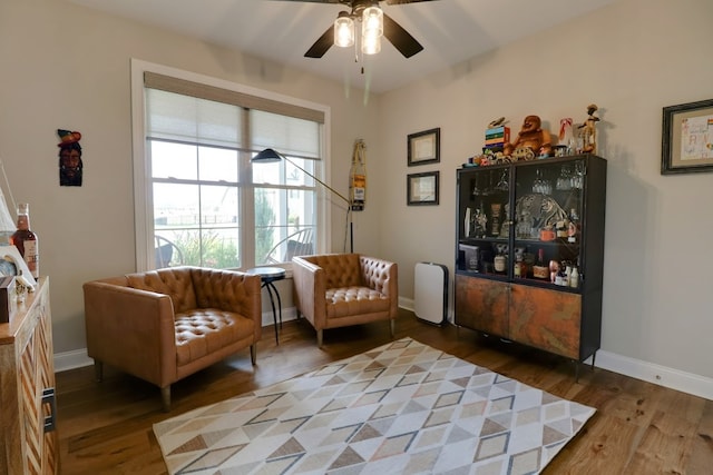 living area with hardwood / wood-style flooring and ceiling fan