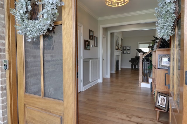 hallway featuring ornamental molding and hardwood / wood-style floors