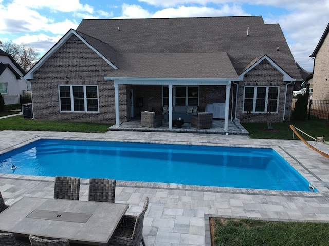 view of pool with an outdoor living space and a patio area