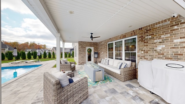 view of patio with an outdoor living space and ceiling fan