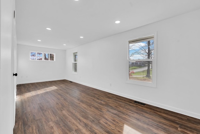 unfurnished room with dark hardwood / wood-style flooring