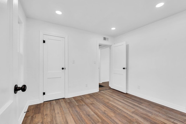 unfurnished bedroom featuring hardwood / wood-style flooring