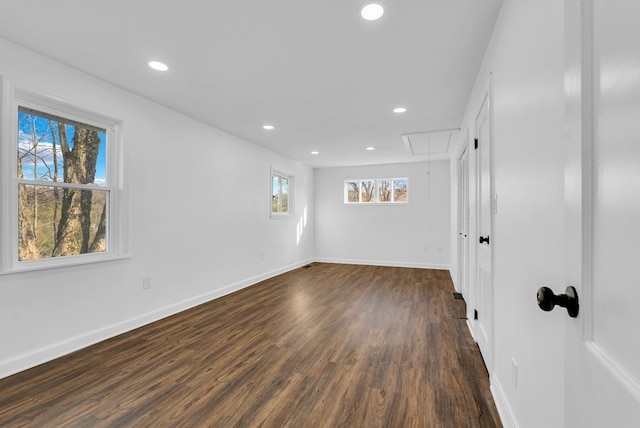 unfurnished room with dark hardwood / wood-style flooring and a wealth of natural light