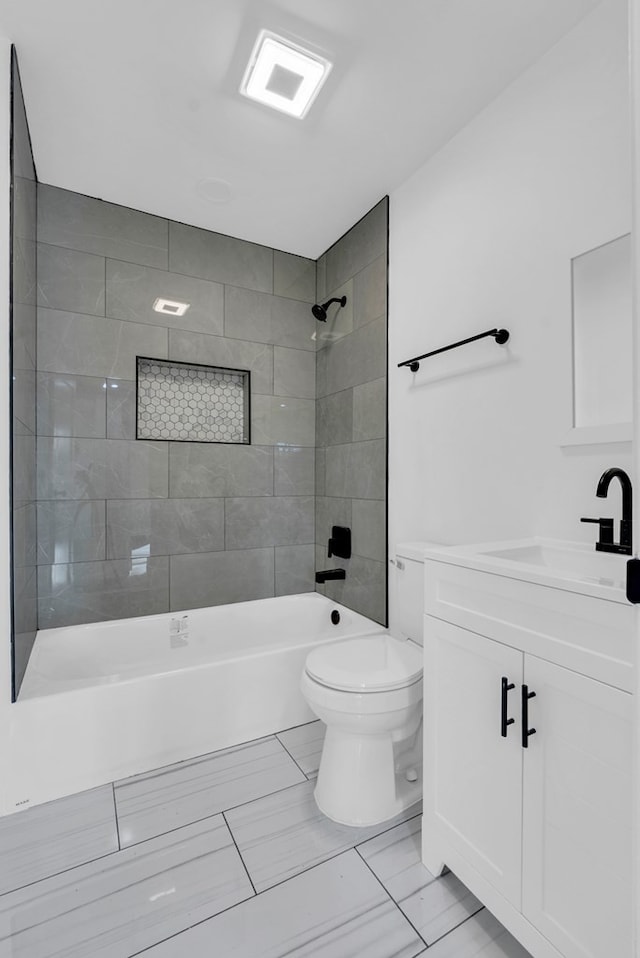 full bathroom with toilet, vanity, and tiled shower / bath combo