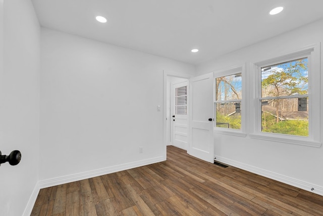 spare room with dark hardwood / wood-style floors