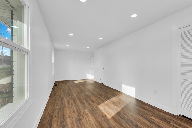 empty room with dark hardwood / wood-style flooring