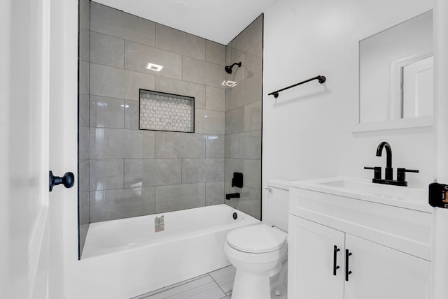 full bathroom featuring tile patterned flooring, vanity, toilet, and tiled shower / bath