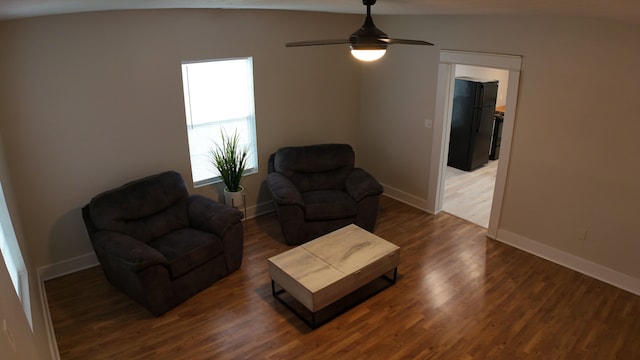 living room with dark hardwood / wood-style floors, ceiling fan, and lofted ceiling