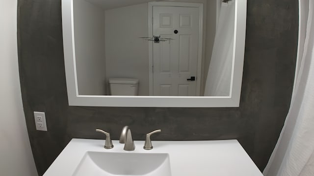 bathroom with decorative backsplash, vanity, and toilet