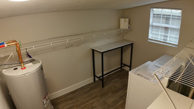 laundry room featuring washer and clothes dryer, dark hardwood / wood-style floors, and gas water heater