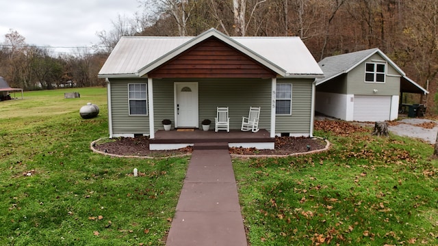 view of front facade with covered porch, a garage, and a front lawn