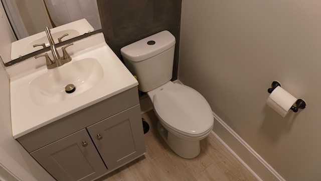 bathroom featuring hardwood / wood-style floors, vanity, and toilet