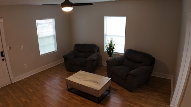 living area featuring dark hardwood / wood-style floors, ceiling fan, and lofted ceiling