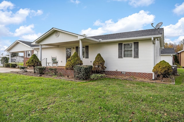 single story home featuring a front yard, covered porch, and central air condition unit