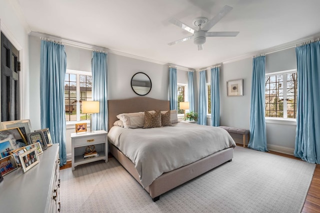 bedroom featuring ceiling fan, wood-type flooring, and ornamental molding