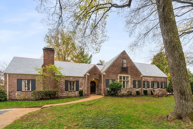 tudor-style house with a front yard