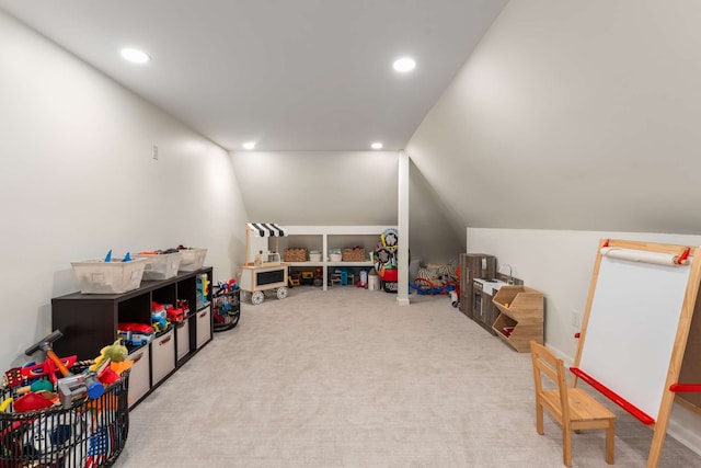 rec room with light colored carpet and vaulted ceiling