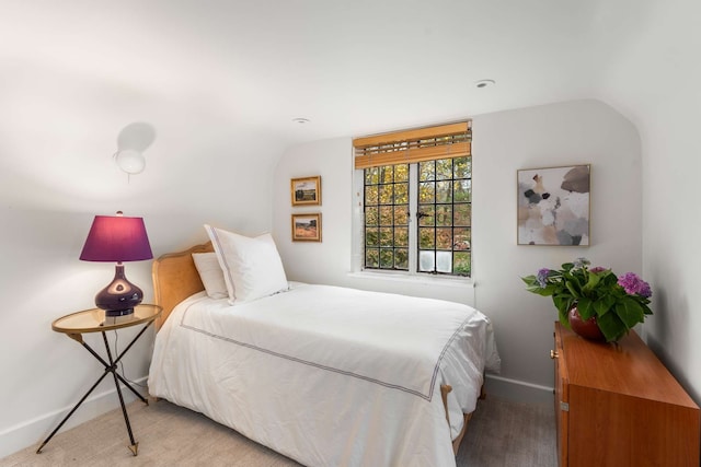 carpeted bedroom with vaulted ceiling