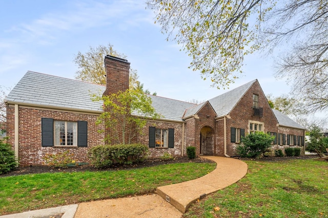 tudor home with a front yard