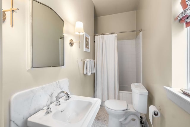 bathroom featuring walk in shower, tile patterned floors, sink, and toilet