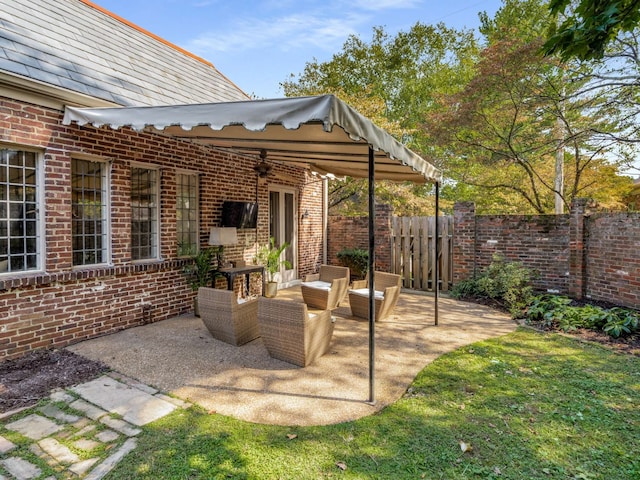 view of patio / terrace with an outdoor living space and ceiling fan