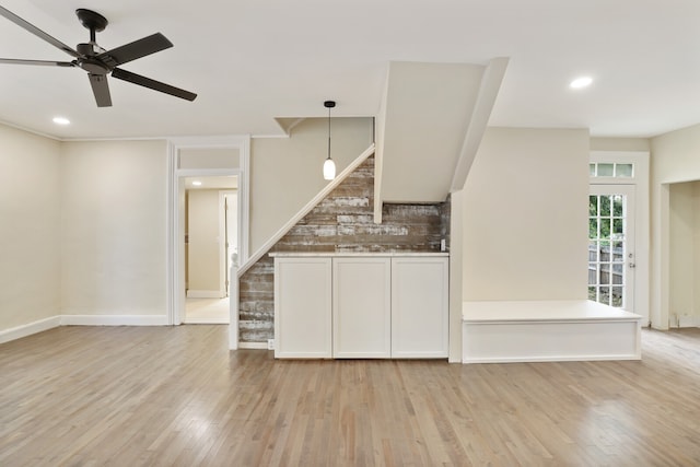 kitchen featuring ceiling fan, decorative backsplash, decorative light fixtures, and light hardwood / wood-style flooring