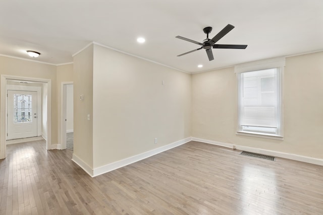 unfurnished room with ceiling fan, plenty of natural light, crown molding, and light hardwood / wood-style flooring